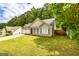 Landscaped front yard of a cozy home featuring a two-car garage and charming curb appeal at 345 Morning Star Dr, Temple, GA 30179