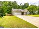Inviting single-Gathering home showcasing a well-kept lawn and a convenient two-car garage at 345 Morning Star Dr, Temple, GA 30179