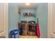 Well-equipped laundry room with modern washer and dryer, shelf, and ample space at 345 Morning Star Dr, Temple, GA 30179
