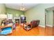 Cozy living room with a fireplace, plush leather seating, and abundant natural light at 345 Morning Star Dr, Temple, GA 30179