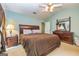 Spacious main bedroom with a ceiling fan, ensuite bathroom, and ample closet space at 345 Morning Star Dr, Temple, GA 30179