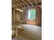 Unfinished attic exhibiting wood framework, a window showing the outdoor scenery, and staircase access at 385 Snead, Fayetteville, GA 30215