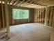 Unfinished attic featuring wood framework, a window view of the surrounding green space, and potential for customization at 385 Snead, Fayetteville, GA 30215