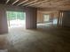 Unfinished basement featuring a concrete foundation, wood framing and a walk-out door with natural light at 385 Snead, Fayetteville, GA 30215