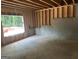 Unfinished basement with visible wood framing, concrete foundation and a window overlooking the property's exterior at 385 Snead, Fayetteville, GA 30215