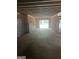Unfinished basement showing concrete foundation, wood framing, and walk-out access to the outdoors at 385 Snead, Fayetteville, GA 30215