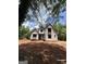 View of the home's exterior under construction surrounded by lush greenery and a partially cloudy sky at 385 Snead, Fayetteville, GA 30215
