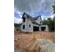View of the home's exterior with visible frame and roof under construction surrounded by trees and sky at 385 Snead, Fayetteville, GA 30215