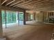 Spacious living room featuring unfinished walls, large windows with lush greenery views, and open floor plan at 385 Snead, Fayetteville, GA 30215