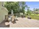 Outdoor deck with table and chairs, perfect for entertaining and enjoying the backyard with mature trees at 557 Spring Creek Ne Way, Marietta, GA 30068