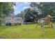 Beautiful view of the backyard showcasing a deck, play area, and lush greenery at 557 Spring Creek Ne Way, Marietta, GA 30068