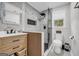 Modern bathroom with elegant tile, walk-in shower, black fixtures, a window, and a stylish vanity at 557 Spring Creek Ne Way, Marietta, GA 30068