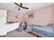 Cozy bedroom with a pink accent wall, plush carpet, and a cozy chair, creating a relaxing atmosphere at 557 Spring Creek Ne Way, Marietta, GA 30068
