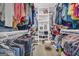 Organized walk-in closet with shelving, hanging rods, and ample space for clothes, shoes, and accessories at 557 Spring Creek Ne Way, Marietta, GA 30068