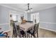 Light-filled dining room featuring a table with seating for six and wood floors and views to other rooms at 557 Spring Creek Ne Way, Marietta, GA 30068
