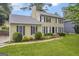 Traditional two-story home with lush landscaping and a classic black front door and shuttered windows at 557 Spring Creek Ne Way, Marietta, GA 30068