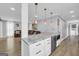 Open-concept kitchen featuring an island with marble countertop and modern pendant lighting above the island at 557 Spring Creek Ne Way, Marietta, GA 30068