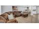Comfortable living room showcasing a large sectional sofa and an open layout with a view into the kitchen at 557 Spring Creek Ne Way, Marietta, GA 30068