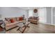 Inviting living room with hardwood floors, comfortable sofas, decorative pillows, and a glass-topped coffee table at 557 Spring Creek Ne Way, Marietta, GA 30068