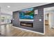 Modern living room featuring an electric fireplace, a mounted TV, and access to the outdoor area at 557 Spring Creek Ne Way, Marietta, GA 30068