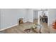 Cozy living room featuring hardwood floors, a glass coffee table, and an integrated pet nook at 557 Spring Creek Ne Way, Marietta, GA 30068