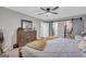 Bright main bedroom showcasing a dresser, walk-in closet, sliding barn door to the bathroom, and closet organizer at 557 Spring Creek Ne Way, Marietta, GA 30068