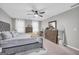Comfortable main bedroom with ample natural light, dresser, ceiling fan, and space for relaxation at 557 Spring Creek Ne Way, Marietta, GA 30068