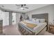 Spacious main bedroom featuring a sliding barn door to the bathroom and walk-in closet, and closet organizer at 557 Spring Creek Ne Way, Marietta, GA 30068