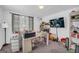 Bright home office space with a large desk, carpeted floors, natural light, and a modern ceiling light at 557 Spring Creek Ne Way, Marietta, GA 30068