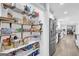 Pantry with organized shelving and food storage containers, adjacent to the kitchen area at 557 Spring Creek Ne Way, Marietta, GA 30068