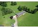 Bird's eye view showcases home with expansive green property and a long driveway at 12621 Highway 142, Oxford, GA 30054