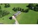 Aerial perspective features home with a yard, basketball hoop and tree coverage at 12621 Highway 142, Oxford, GA 30054