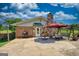 Outdoor patio area featuring a stone fireplace, seating, grill, and concrete flooring ideal for entertaining at 12621 Highway 142, Oxford, GA 30054