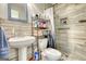 Modern bathroom with a pedestal sink, stylish fixtures, and a shower, offering a clean and contemporary design at 12621 Highway 142, Oxford, GA 30054