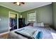Bedroom featuring a large closet, wood-paneled walls, and natural light at 12621 Highway 142, Oxford, GA 30054