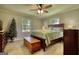 Bedroom with natural light, ceiling fan, and wood floors at 12621 Highway 142, Oxford, GA 30054