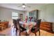 Elegant dining room features a large table with seating for six, a decorative hutch, and natural light at 12621 Highway 142, Oxford, GA 30054