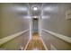 Long hallway with wood floors, neutral walls, and recessed lighting, offering a clean and inviting passage at 12621 Highway 142, Oxford, GA 30054