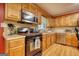 Functional kitchen featuring wood cabinets, modern appliances, and ample countertop space for cooking at 12621 Highway 142, Oxford, GA 30054