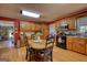 Cozy kitchen with wooden cabinetry, black appliances, and a round table with seating for four at 12621 Highway 142, Oxford, GA 30054