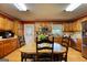 Charming kitchen with light wood cabinets, stainless steel appliances, and cozy breakfast table at 12621 Highway 142, Oxford, GA 30054