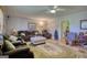 Comfortable living room area featuring carpeted flooring, ceiling fan, and neutral toned walls at 12621 Highway 142, Oxford, GA 30054