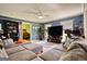 Comfortable living room featuring a large sectional sofa, entertainment center, and stylish decor at 12621 Highway 142, Oxford, GA 30054