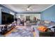 Spacious living room with hardwood floors, large sectional, and recessed lighting at 12621 Highway 142, Oxford, GA 30054