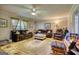 Cozy living room featuring carpeted flooring, comfortable seating, and a ceiling fan at 12621 Highway 142, Oxford, GA 30054