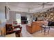 Spacious living area with stone fireplace, comfortable leather seating, and large windows at 12621 Highway 142, Oxford, GA 30054