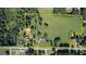Aerial perspective outlining a property featuring lush greenery, buildings, and a pond at 12621 Highway 142, Oxford, GA 30054
