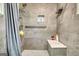 Contemporary shower with gray tiling, a built-in niche, and seating at 12621 Highway 142, Oxford, GA 30054