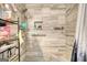 Modern shower with marble-look tiling, built-in shelf, and convenient grab bar at 12621 Highway 142, Oxford, GA 30054