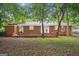 Exterior view of backyard with a brick house, porch and greenery at 2858 Valley Ridge Dr, Decatur, GA 30032
